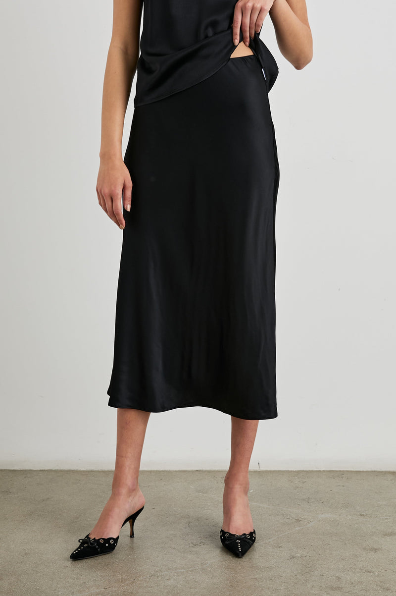 Anya Skirt in Black satin, front view on model