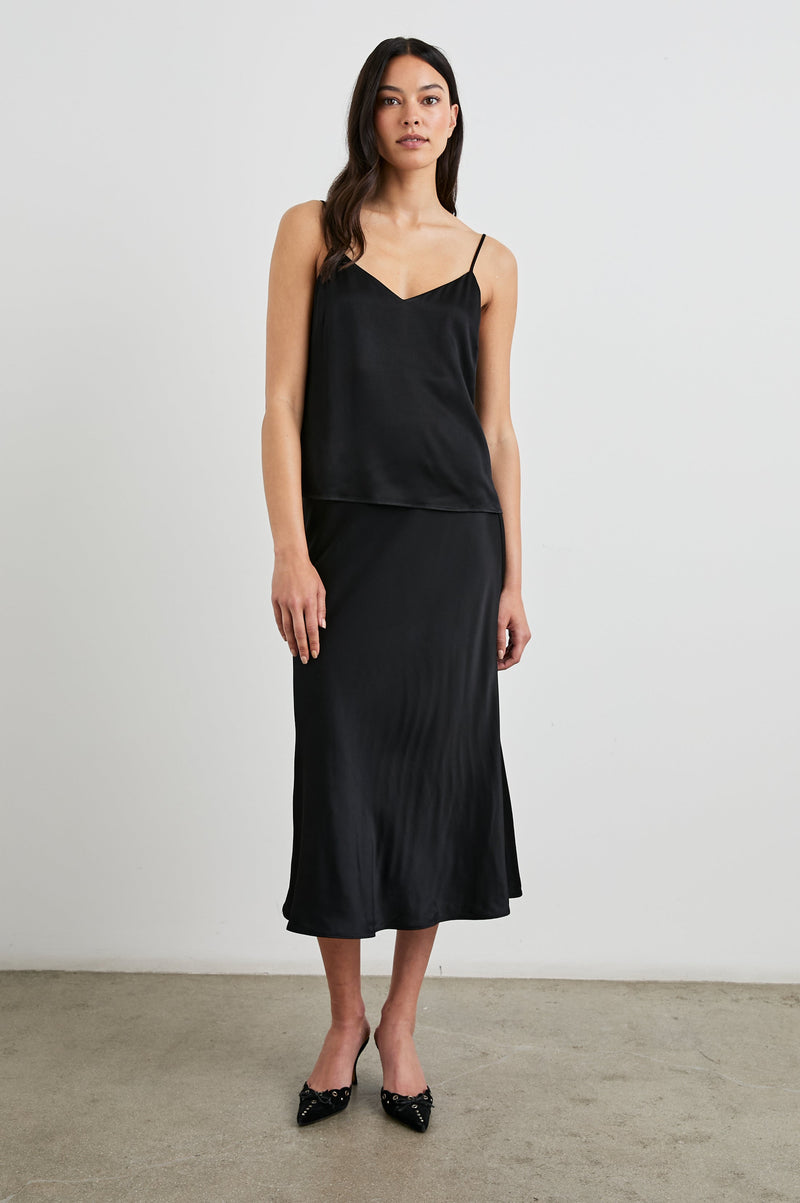 Anya Skirt in Black satin, full length front view on model